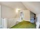 Upper level hallway with white railing and green carpet at 9490 N 700 E, Indianapolis, IN 46259