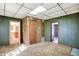 Living area with green walls, carpet, and access to kitchen at 9490 N 700 E, Indianapolis, IN 46259