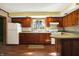 Kitchen with wood cabinets, laminate countertops and hardwood floors at 9490 N 700 E, Indianapolis, IN 46259