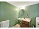 Small bathroom with pedestal sink, toilet, and mirror at 9490 N 700 E, Indianapolis, IN 46259