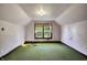 Unfinished attic bedroom with green carpet and one window at 9490 N 700 E, Indianapolis, IN 46259
