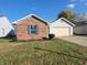 Brick and blue siding ranch home with attached garage at 1493 Green Spring Way, Greenwood, IN 46143