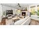 Bright sunroom with a fireplace, hardwood floors, and access to the backyard at 11730 Ansley Ct, Zionsville, IN 46077