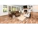 Cozy living room featuring a fireplace, hardwood floors, and comfortable seating at 11730 Ansley Ct, Zionsville, IN 46077