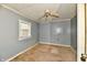 Small bedroom needing renovation, grey walls, and old carpet at 214 Tippecanoe Dr, Noblesville, IN 46062
