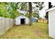 Backyard view showing shed with open door and mature trees at 214 Tippecanoe Dr, Noblesville, IN 46062