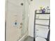 Clean bathroom with shower/tub combo and storage shelf at 11815 Nelson Rd, Martinsville, IN 46151