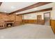Finished basement with exposed beams and fireplace at 11741 W Grandview Dr, Columbus, IN 47201
