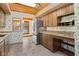 Kitchen features wood cabinets, granite countertops, and stainless steel appliances at 11741 W Grandview Dr, Columbus, IN 47201