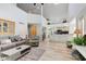 Open living room with vaulted ceilings, hardwood floors, and a view of kitchen at 6438 Pin Oak Dr, McCordsville, IN 46055