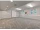 Finished basement with grey carpeting and barn door at 6438 Pin Oak Dr, McCordsville, IN 46055