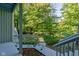 Deck overlooks wooded backyard with steps leading down to patio at 6438 Pin Oak Dr, McCordsville, IN 46055