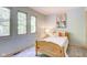 Bright bedroom with a twin bed and ample natural light from large windows at 6438 Pin Oak Dr, McCordsville, IN 46055