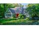 Charming blue house with a red door and a landscaped yard at 6438 Pin Oak Dr, McCordsville, IN 46055