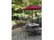 Brick patio with table, chairs, and umbrella, overlooking a pond at 6438 Pin Oak Dr, McCordsville, IN 46055