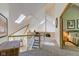 Bright upper hallway with skylights, hardwood floors and views to bedrooms at 6438 Pin Oak Dr, McCordsville, IN 46055