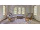 Relaxing sitting room with wicker chairs and large windows at 6438 Pin Oak Dr, McCordsville, IN 46055