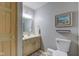 Clean and simple half bathroom with light wood vanity and framed art at 6438 Pin Oak Dr, McCordsville, IN 46055
