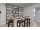Basement wet bar with wooden countertop and stylish barstools at 6438 Pin Oak Dr, McCordsville, IN 46055