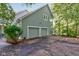 Two-car garage with large driveway and landscaping at 6438 Pin Oak Dr, McCordsville, IN 46055