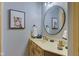 Clean bathroom with a large vanity, round mirror and neutral color scheme at 6438 Pin Oak Dr, McCordsville, IN 46055