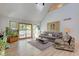 Spacious living room with hardwood floors, comfy seating, and access to deck at 6438 Pin Oak Dr, McCordsville, IN 46055