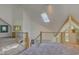 Open upper hallway with skylights, high ceilings and views to lower level at 6438 Pin Oak Dr, McCordsville, IN 46055