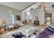 Spacious living room with hardwood floors, large windows, and vaulted ceilings at 6438 Pin Oak Dr, McCordsville, IN 46055