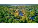 Aerial view showcasing a neighborhood with houses and a pond at 6438 Pin Oak Dr, McCordsville, IN 46055