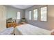 Serene bedroom featuring a twin bed, wooden chair, and calming decor at 6438 Pin Oak Dr, McCordsville, IN 46055