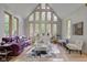 Spacious living room with vaulted ceilings and purple sofa at 6438 Pin Oak Dr, McCordsville, IN 46055