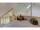 Comfortable sitting area on upper level with couch, chess table, and skylights at 6438 Pin Oak Dr, McCordsville, IN 46055