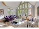 Spacious living room with vaulted ceilings and purple sofa at 6438 Pin Oak Dr, McCordsville, IN 46055