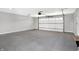 Spacious two-car garage with polished concrete floor and overhead storage at 7234 N Christopher Ln, Fairland, IN 46126