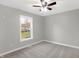 Simple bedroom with ceiling fan and large window at 7234 N Christopher Ln, Fairland, IN 46126