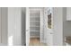 Open pantry with white shelves and wood flooring at 7234 N Christopher Ln, Fairland, IN 46126