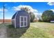 Large gray shed with double doors in the backyard at 7234 N Christopher Ln, Fairland, IN 46126
