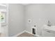 Bright laundry room with utility sink and built-in pet door at 7234 N Christopher Ln, Fairland, IN 46126
