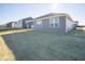 Gray house with covered patio and grassy backyard at 7920 Magnolia St, New Palestine, IN 46163
