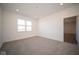 Well-lit bedroom featuring grey carpet and an exterior view at 7920 Magnolia St, New Palestine, IN 46163