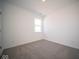 Simple bedroom with grey carpet and a window at 7920 Magnolia St, New Palestine, IN 46163