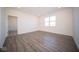 Large bedroom with grey vinyl flooring and access to another room at 7920 Magnolia St, New Palestine, IN 46163