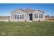 Gray and brick one-story home with a landscaped lawn and blue door at 7920 Magnolia St, New Palestine, IN 46163