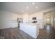 Modern kitchen with white cabinets and a large island at 7920 Magnolia St, New Palestine, IN 46163