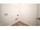 Bright laundry room with built-in shelving and vinyl flooring at 7920 Magnolia St, New Palestine, IN 46163