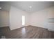 Spacious living room with wood-look flooring and door access at 7920 Magnolia St, New Palestine, IN 46163