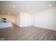 Bright living room with wood-look floors and access to kitchen at 7920 Magnolia St, New Palestine, IN 46163