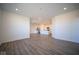Open living room with wood-look floors and kitchen view at 7920 Magnolia St, New Palestine, IN 46163