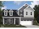 Two story home with gray siding, stone accents, and a 2-car garage at 5710 Cloister Ln, McCordsville, IN 46055