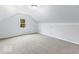 A bright attic bedroom with gray walls and carpet at 6338 Douglas Rd, Indianapolis, IN 46220